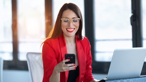 woman in red using technology_iStock-1181864446-modified-8ad63574-e875-4021-9645-b0da6d40b6ca